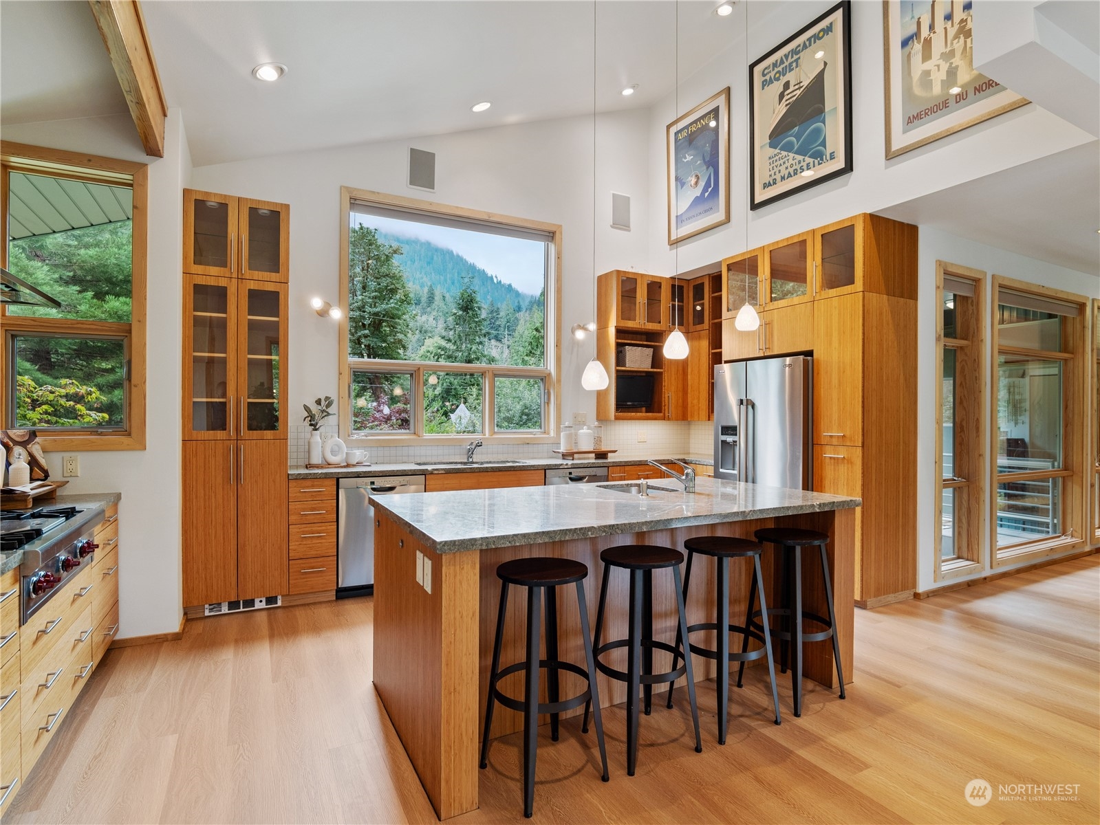 51417 South Riverside Road Gold Bar, WA 98251 - Photo 13 of 40 a kitchen with stainless steel appliances granite countertop a table chairs and a refrigerator