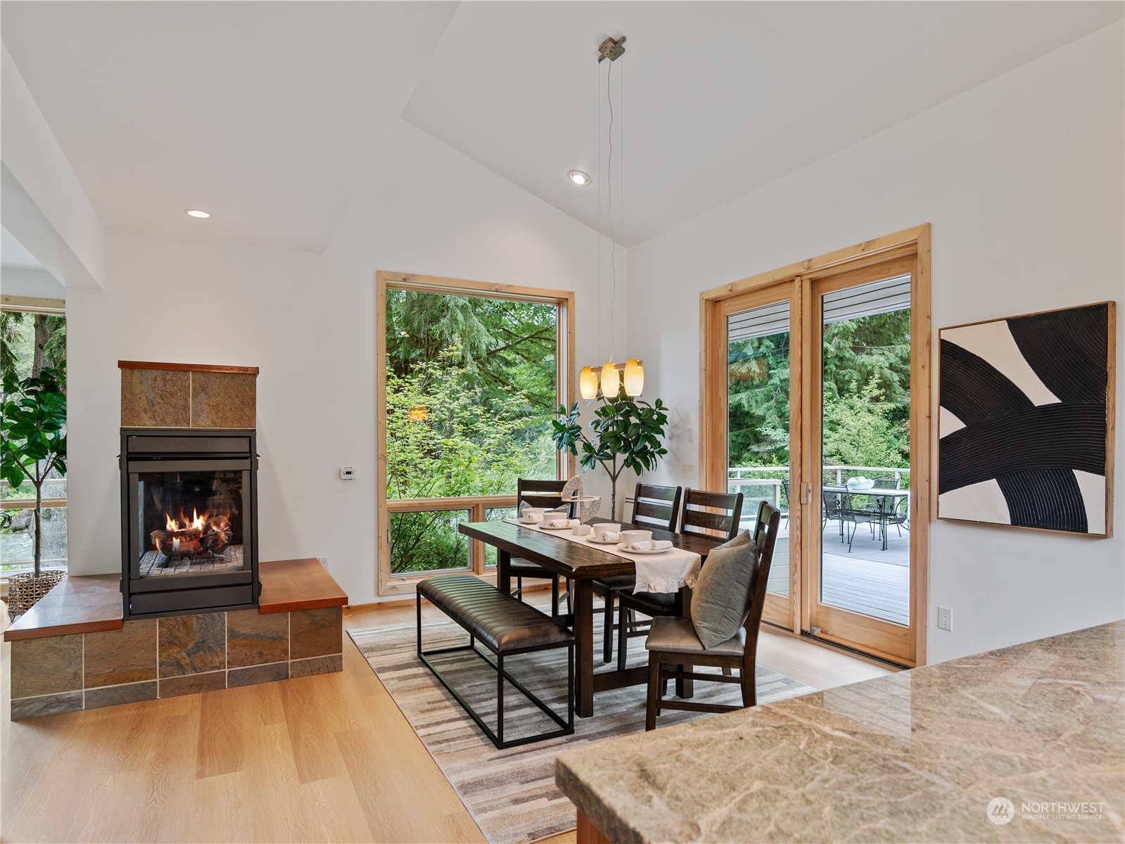 51417 South Riverside Road Gold Bar, WA 98251 - Photo 16 of 40 a dining room with furniture and a fireplace