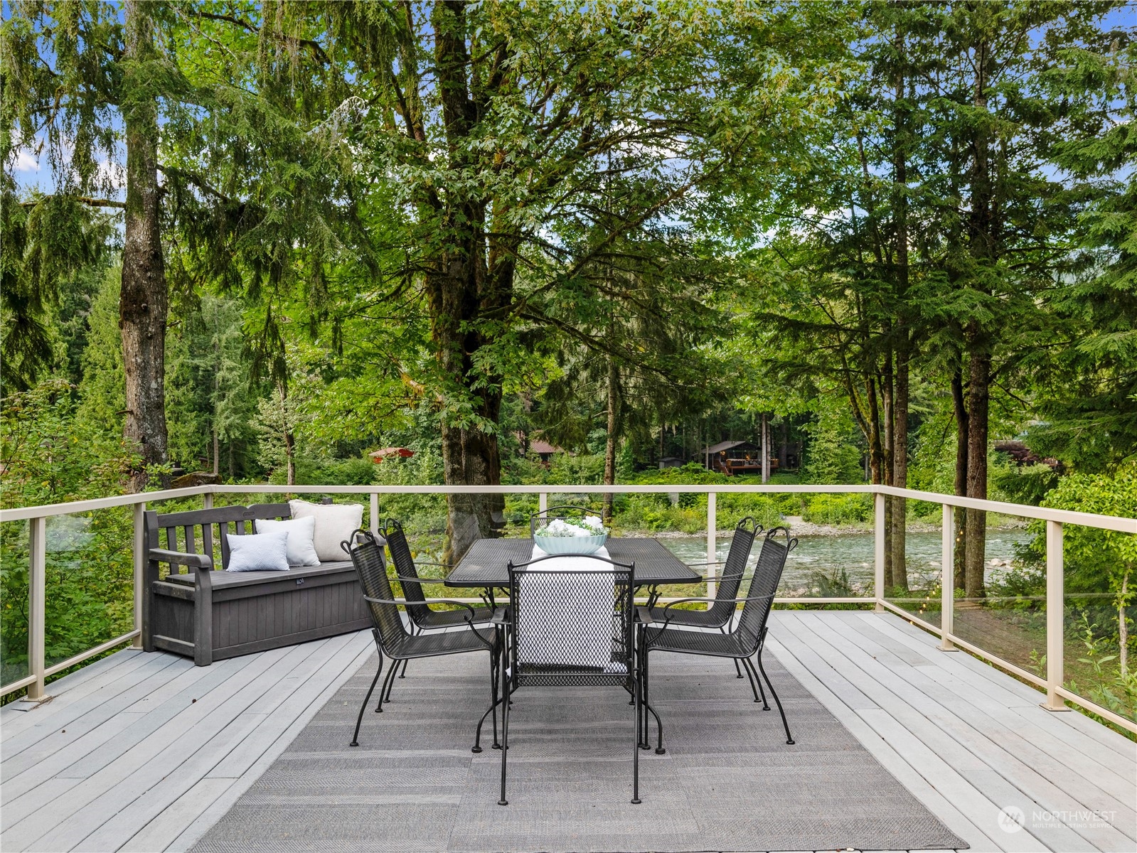 51417 South Riverside Road Gold Bar, WA 98251 - Photo 18 of 40 a balcony with wooden floor table and chairs
