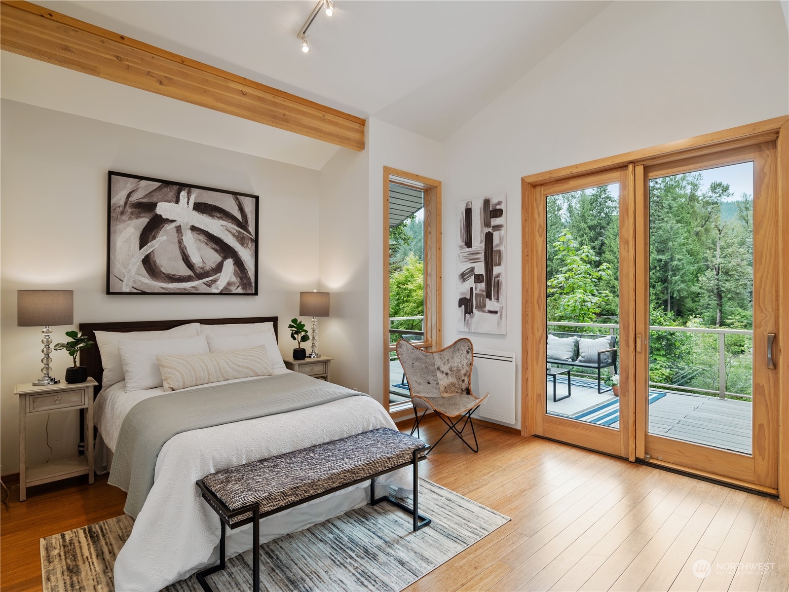 51417 South Riverside Road Gold Bar, WA 98251 - Photo 19 of 40 a bedroom with a large bed and a large window with outer view