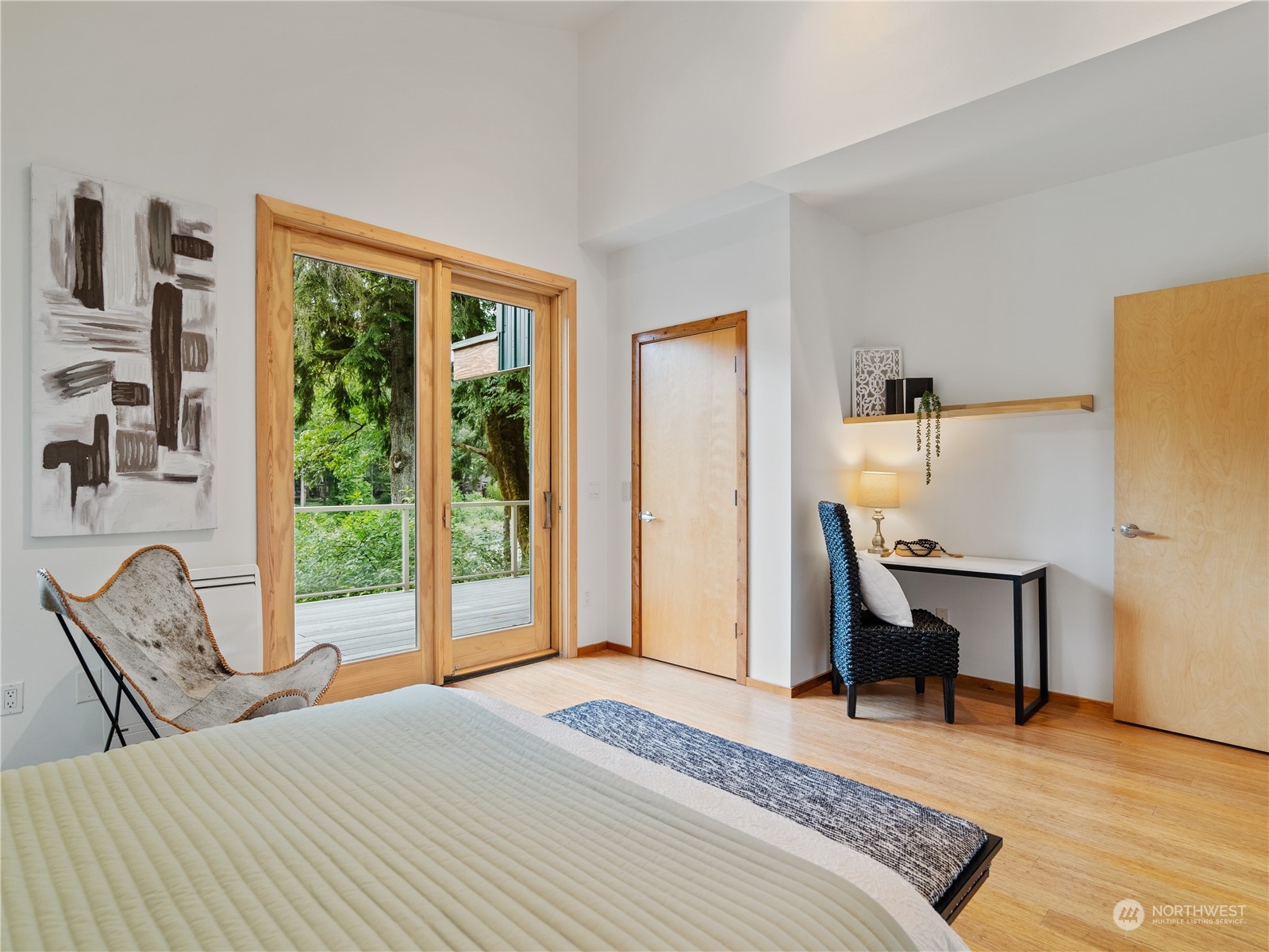 51417 South Riverside Road Gold Bar, WA 98251 - Photo 20 of 40 a bedroom with a bed a large window with table and chair