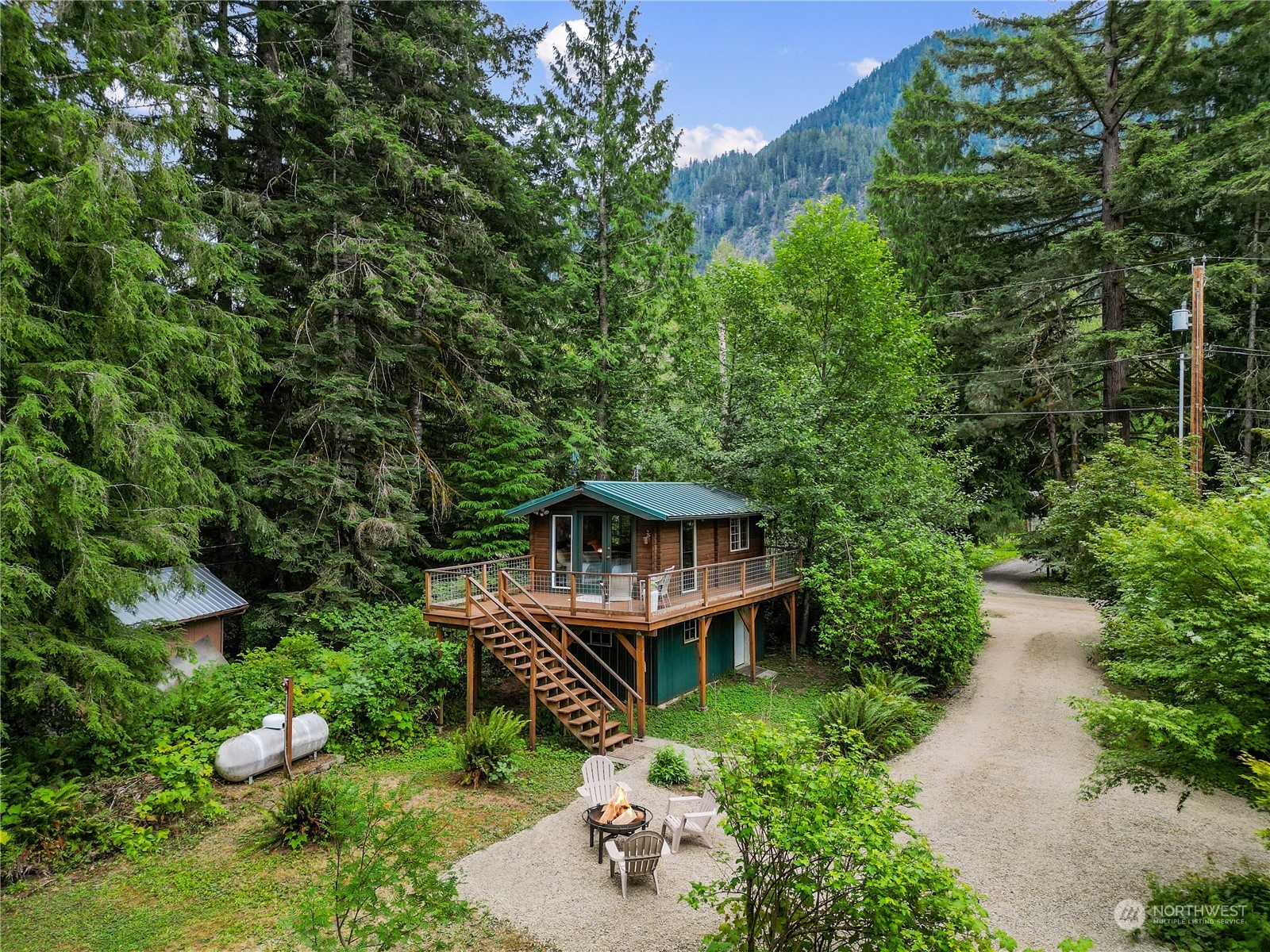 51417 South Riverside Road Gold Bar, WA 98251 - Photo 30 of 40 a view of a house with a yard and large trees