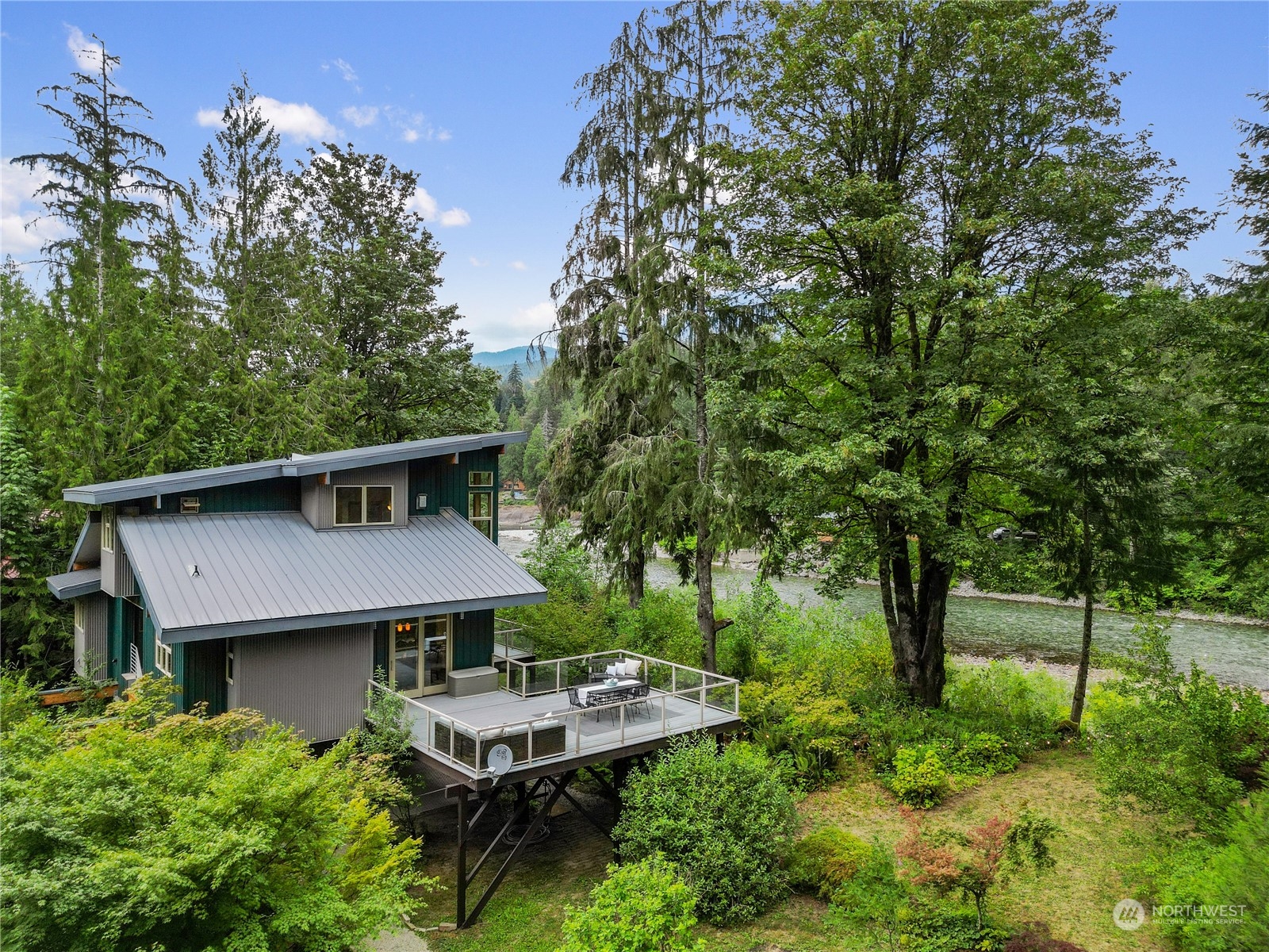 51417 South Riverside Road Gold Bar, WA 98251 - Photo 4 of 40 an aerial view of a house with swimming pool and garden