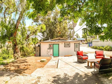 a backyard of a house with yard and outdoor seating