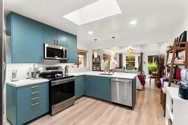 a kitchen with stainless steel appliances kitchen island granite countertop a sink and cabinets