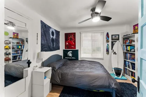a bedroom with a bed and a book shelf