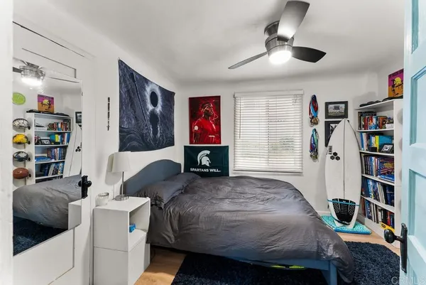 a bedroom with a bed and a book shelf