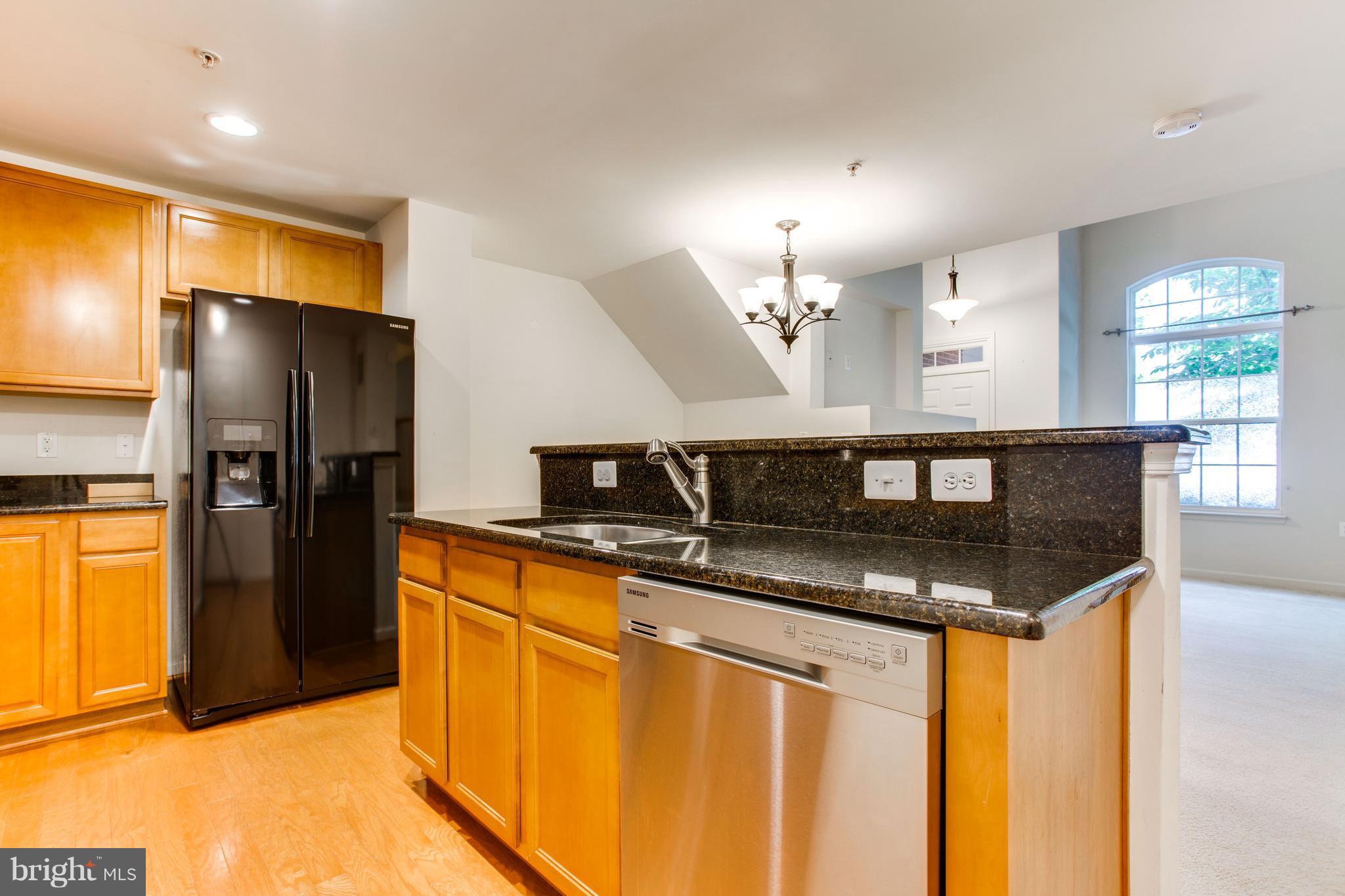 6020 Machen Road, Unit 177 Centreville, VA 20121 - Photo 11 of 30 a kitchen with stainless steel appliances granite countertop a sink and a refrigerator