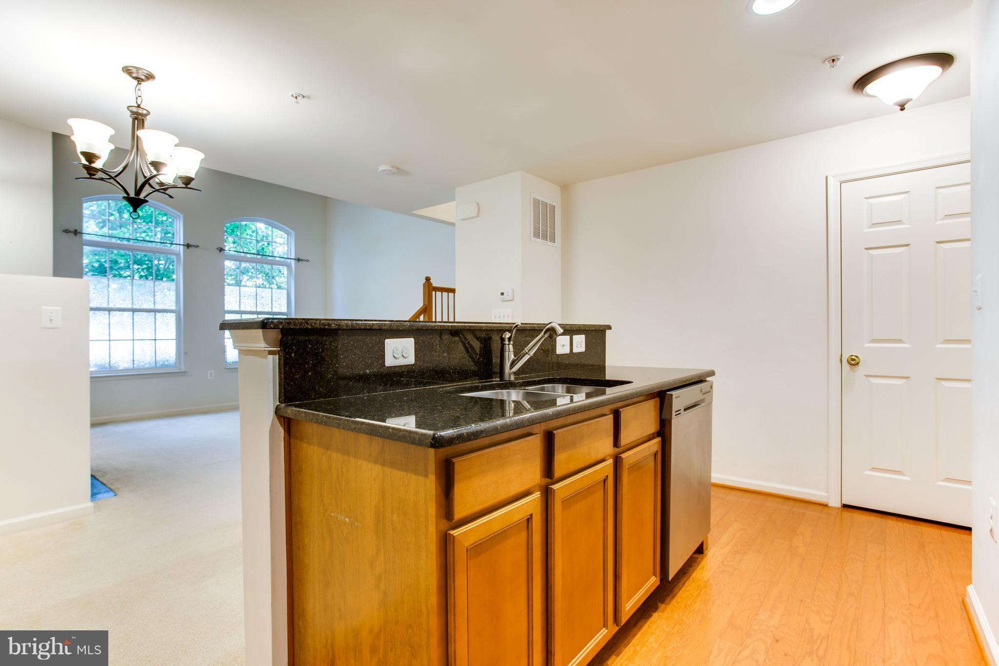 6020 Machen Road, Unit 177 Centreville, VA 20121 - Photo 12 of 30 a view of kitchen island with wooden floor