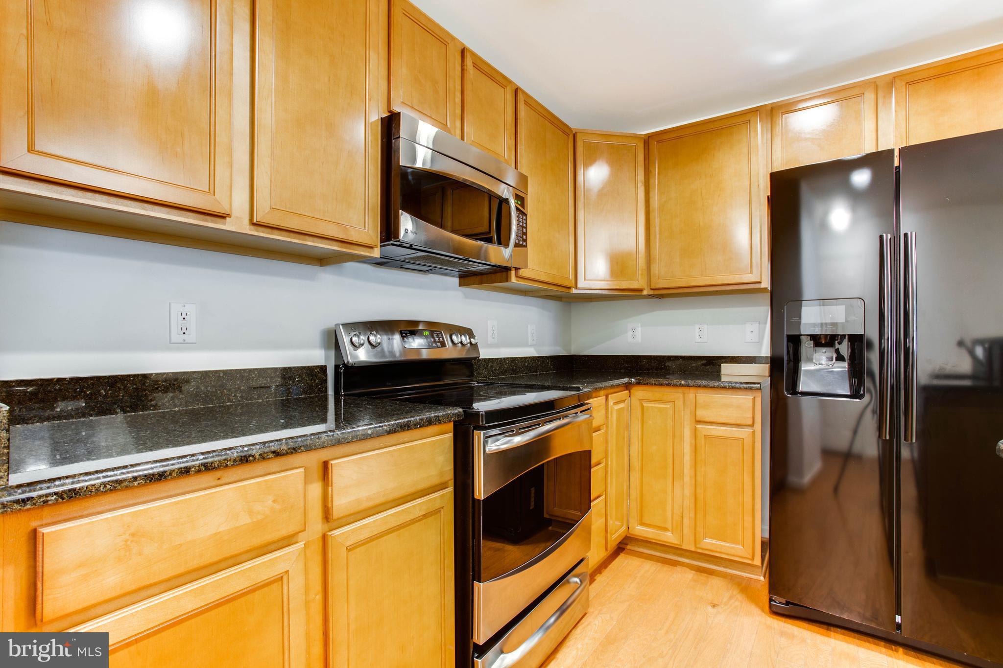 6020 Machen Road, Unit 177 Centreville, VA 20121 - Photo 13 of 30 a kitchen with stainless steel appliances granite countertop a refrigerator a stove and a sink