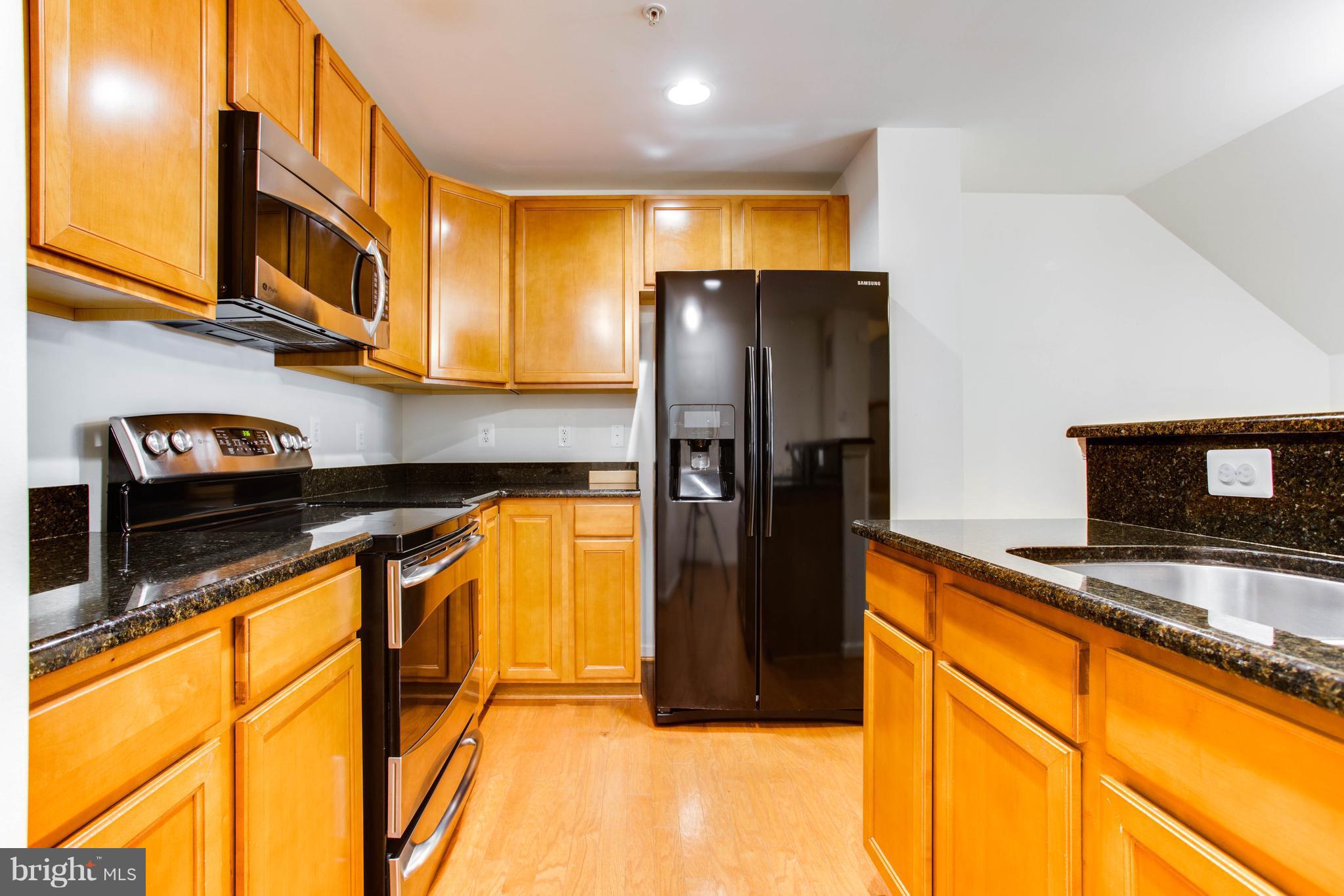 6020 Machen Road, Unit 177 Centreville, VA 20121 - Photo 14 of 30 a kitchen with stainless steel appliances granite countertop a refrigerator a oven and a sink