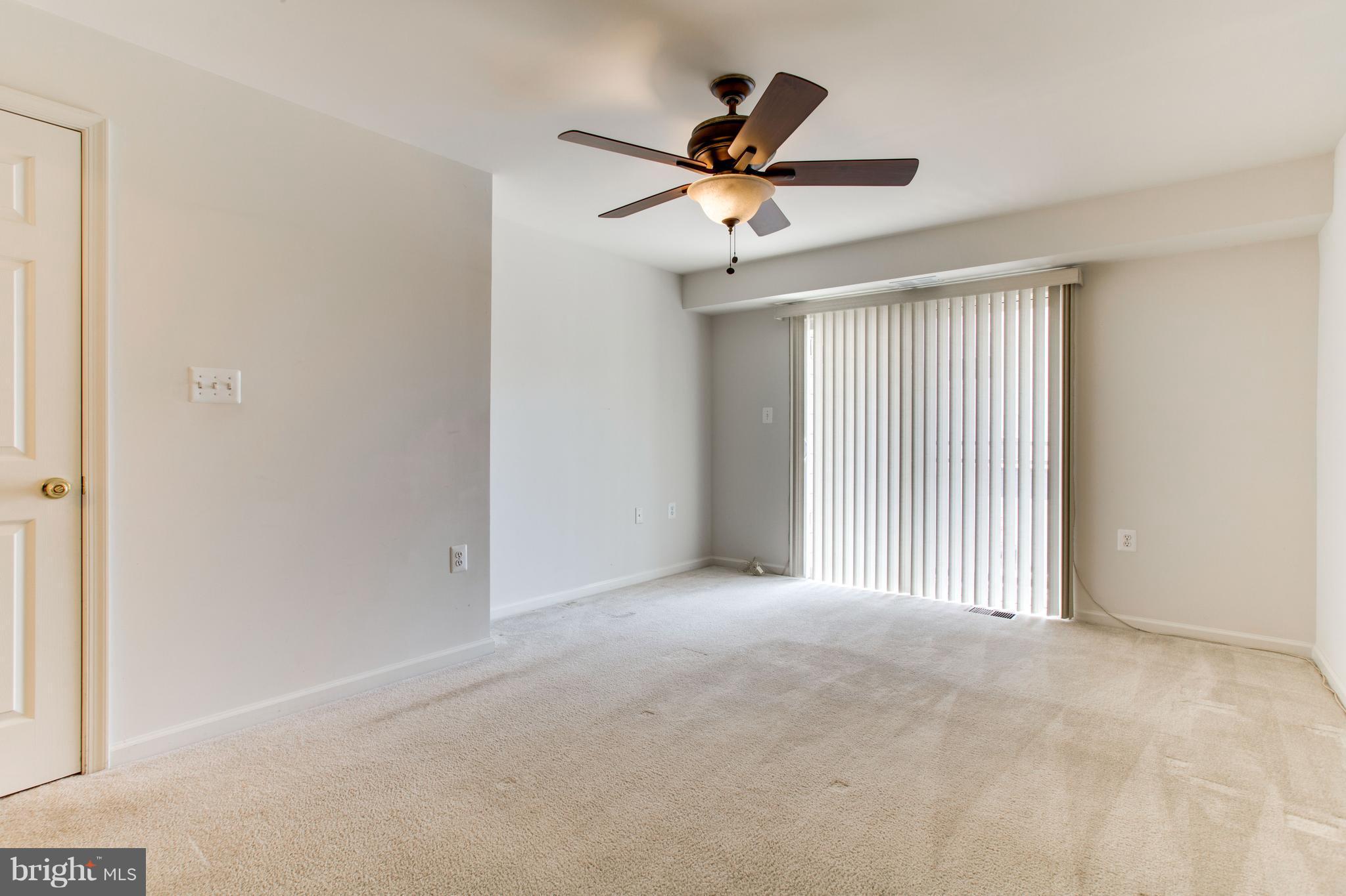 6020 Machen Road, Unit 177 Centreville, VA 20121 - Photo 23 of 30 a view of a livingroom with a ceiling fan and wooden floor