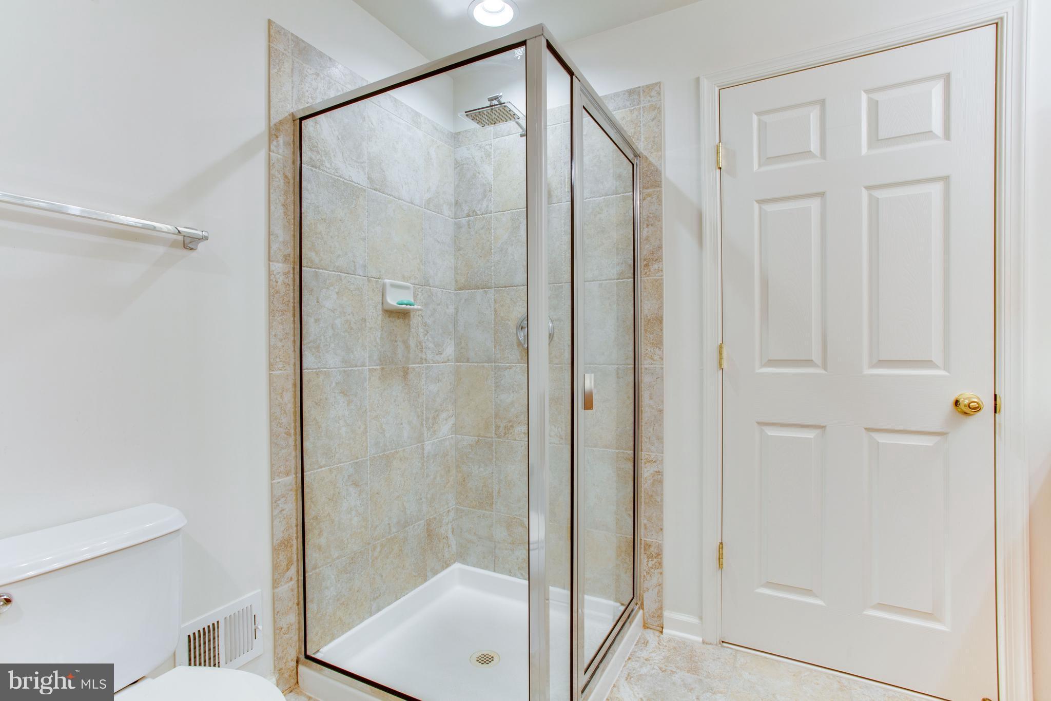 6020 Machen Road, Unit 177 Centreville, VA 20121 - Photo 28 of 30 a bathroom with a glass shower door