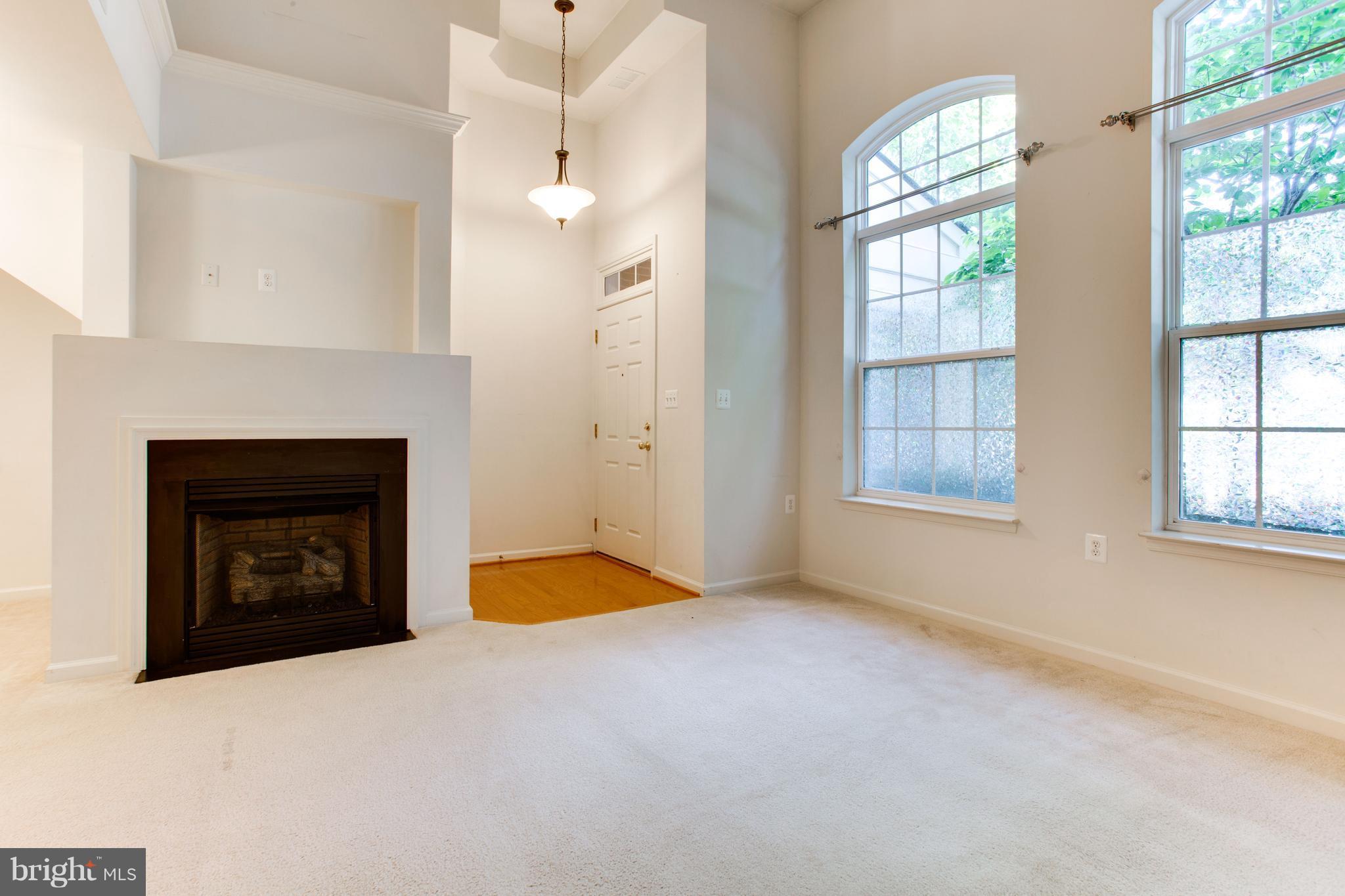 6020 Machen Road, Unit 177 Centreville, VA 20121 - Photo 4 of 30 an empty room with windows and fireplace