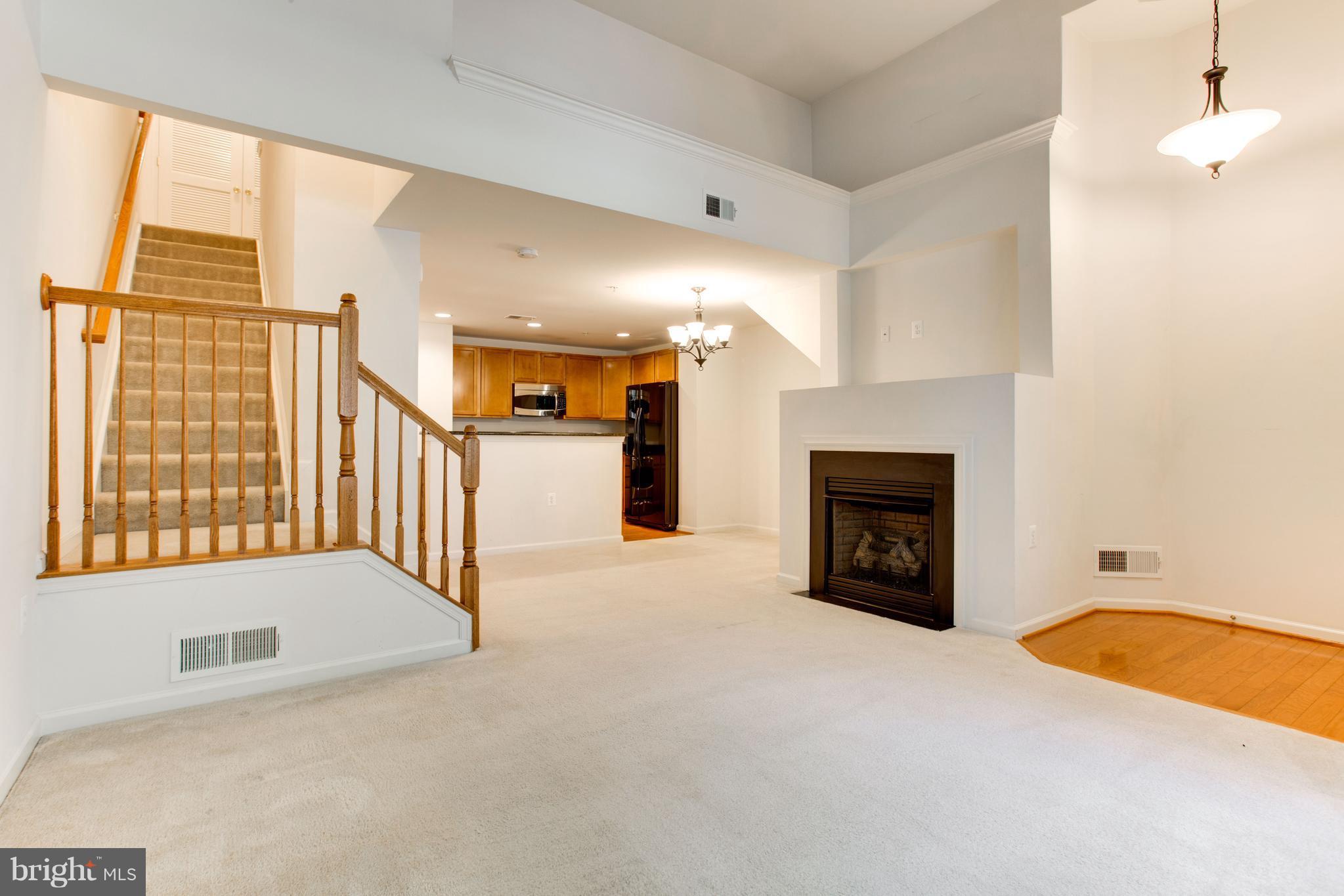 6020 Machen Road, Unit 177 Centreville, VA 20121 - Photo 7 of 30 a view of an empty room with a fireplace and a window