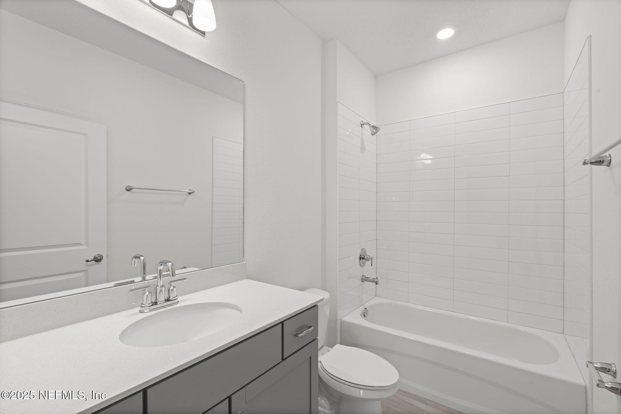 81 Ripple Road St. Augustine, FL 32095 - Photo 31 of 94 a bathroom with a bathtub shower sink vanity mirror and toilet