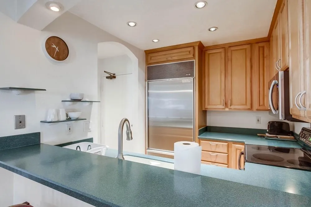 6767 Friars Road, Unit 150 San Diego, CA 92108 - Photo 6 of 20 a kitchen with a refrigerator and a stove top oven