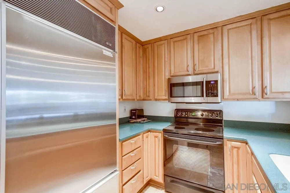 6767 Friars Road, Unit 150 San Diego, CA 92108 - Photo 7 of 20 a kitchen with stainless steel appliances granite countertop a stove and a microwave