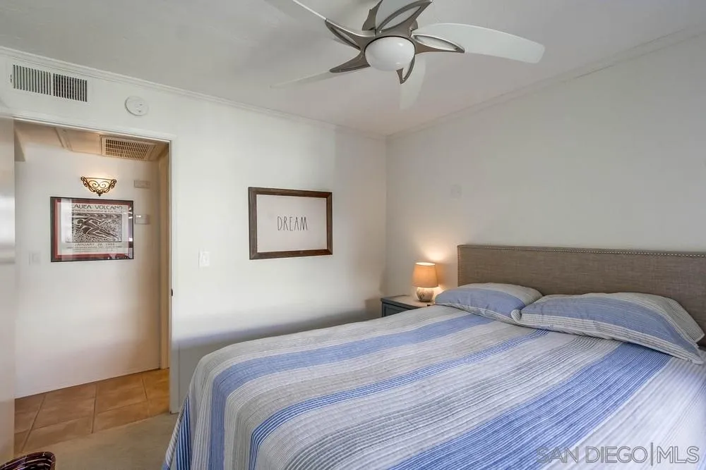 6767 Friars Road, Unit 150 San Diego, CA 92108 - Photo 9 of 20 a bedroom with a bed and a painting on the wall
