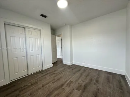 a view of an empty room and wooden floor