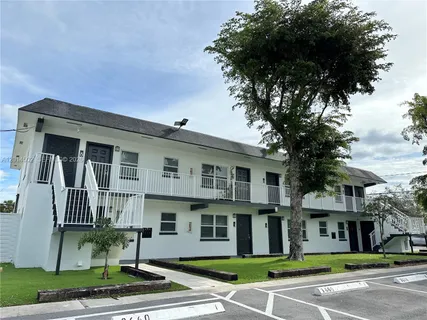 a front view of a residential apartment building with a yard