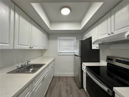 a kitchen that has a sink and a stove