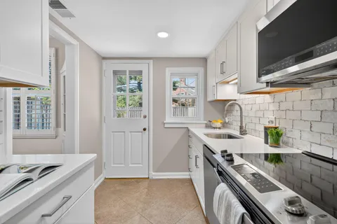 a kitchen with a sink stove top oven and cabinets
