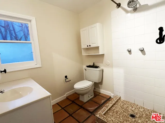 a white toilet sitting next to a bathroom sink
