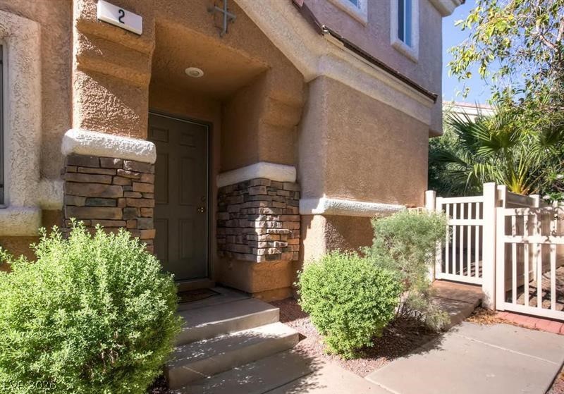 79 Stock Option Street, Unit 2 Henderson, NV 89074 - Photo 2 of 4 A welcoming entry, complete with stone accents and mature landscaping, beckons residents and guests alike.