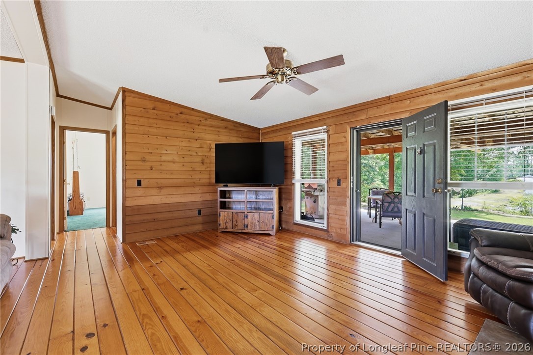 10400 Ruth Vinson Road Autryville, NC 28318 - Photo 24 of 49 a living room with furniture wooden floor and a flat screen tv