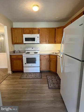 a kitchen with a stove a refrigerator and a microwave