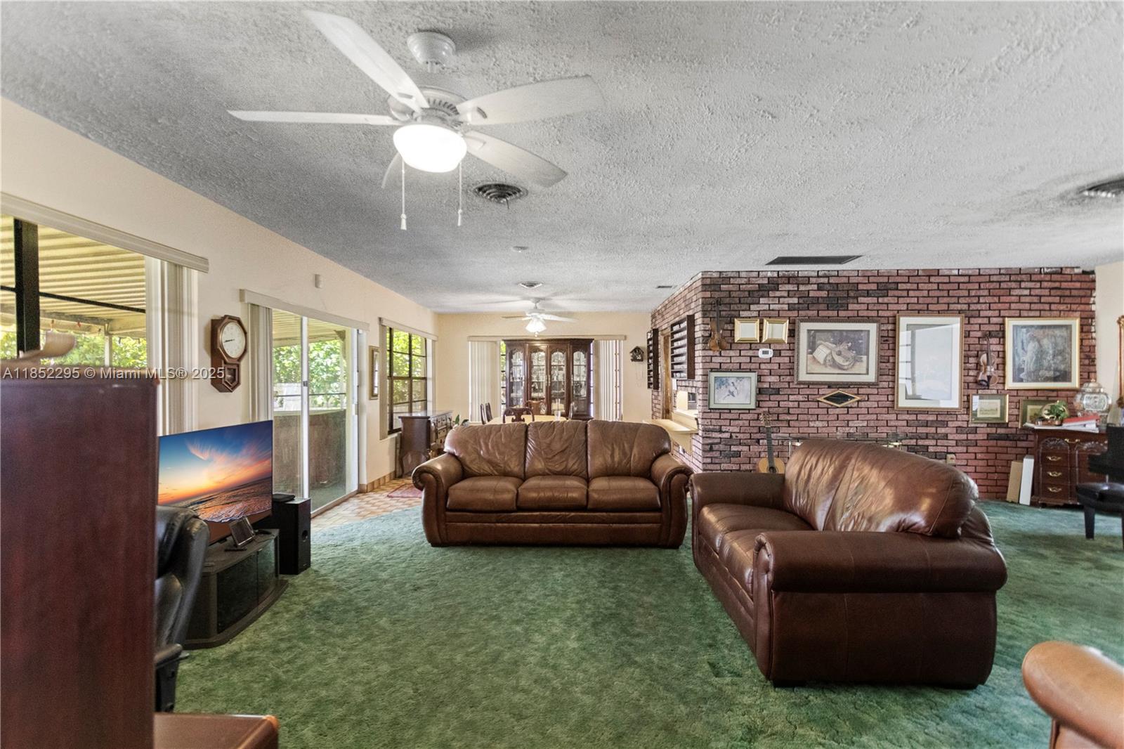 4322 Alton Road Miami Beach, FL 33140 - Photo 11 of 26 a living room with furniture and a flat screen tv