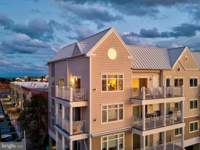 a front view of a residential apartment building with a yard