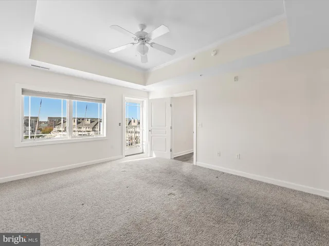 a bed room with a bed and a large window