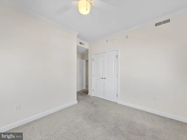 a view of a lake with boats and trees in the background