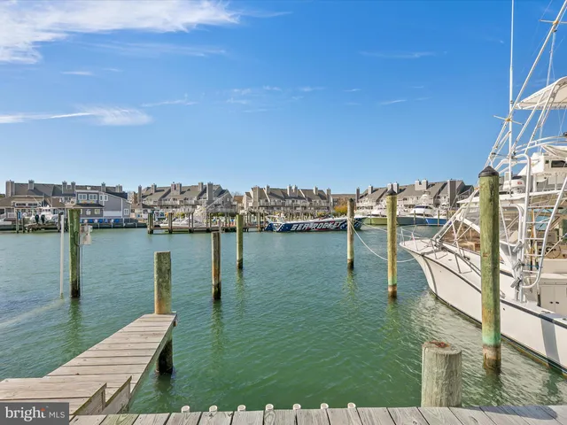 a view of a lake with lawn chairs