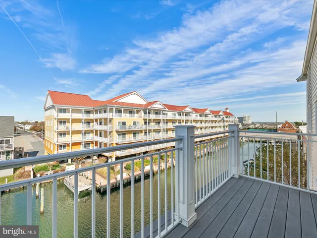 a front view of a residential apartment building with a yard