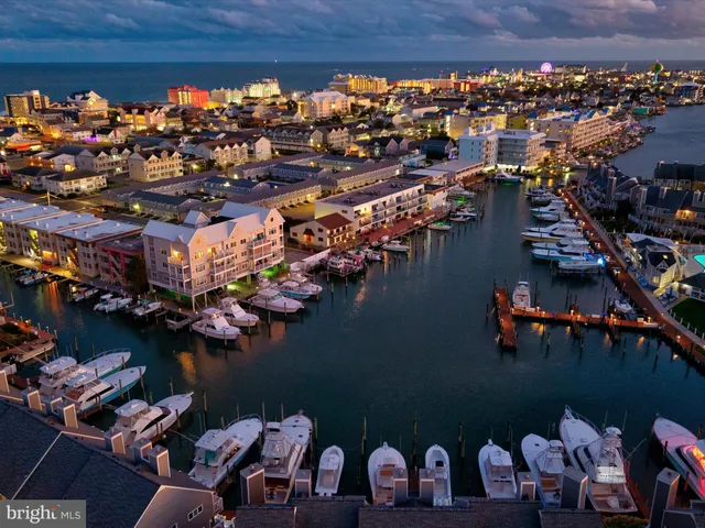 a open dining room with furniture a kitchen view and a chandelier