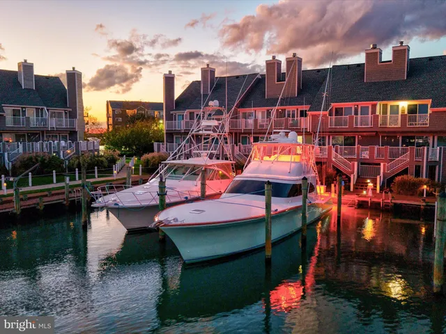 a living room with furniture fireplace and a large window