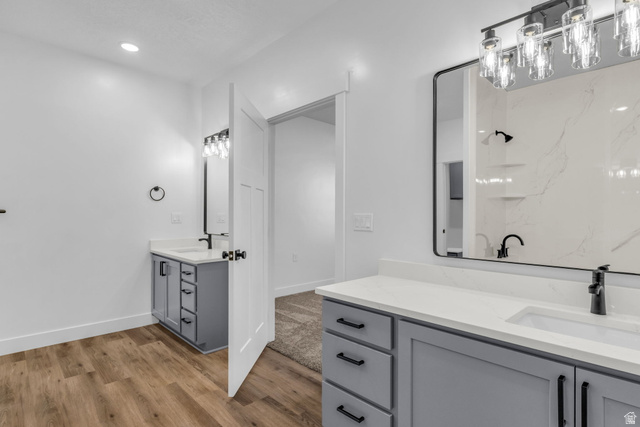 520 East 450th Street North Delta, UT 84624 - Photo 23 of 48 Full bathroom featuring two vanities, light wood-type flooring, and recessed lighting