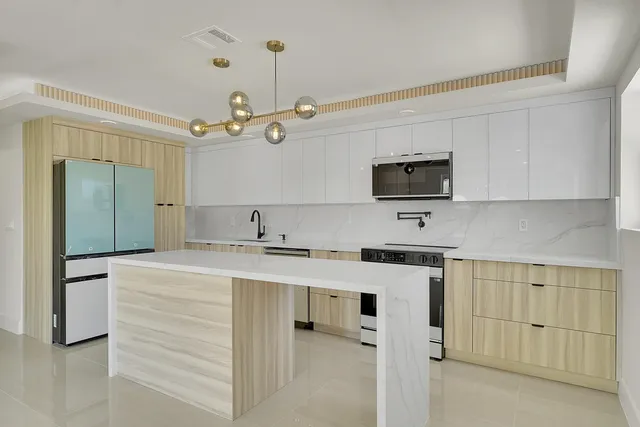 a kitchen with a stove oven and white cabinets