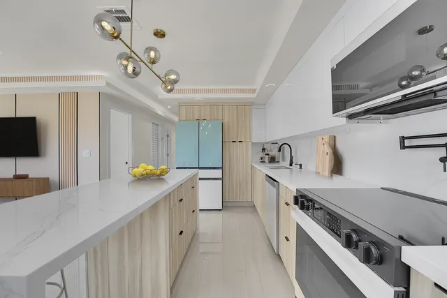 a kitchen with a sink appliances and cabinets