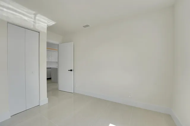 a living room with furniture and a walk in closet