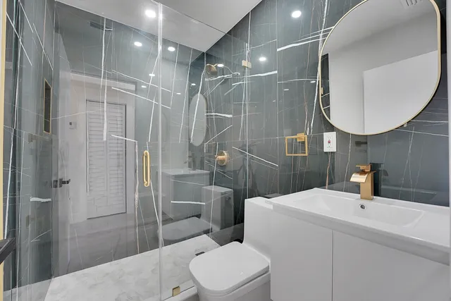 a bathroom with a toilet sink and mirror