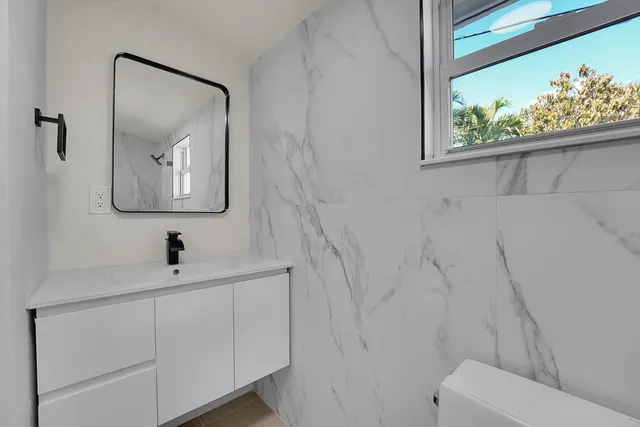 a view of backyard with plants and outdoor seating