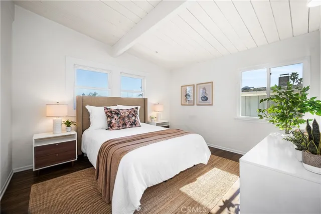a bedroom with bed and a potted plant