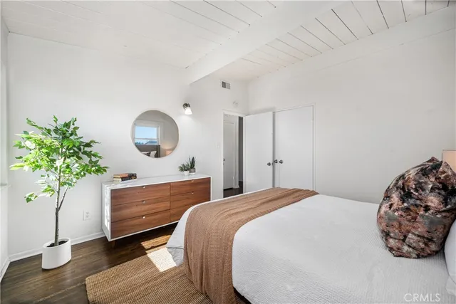 a bed room with a bed and a potted plant
