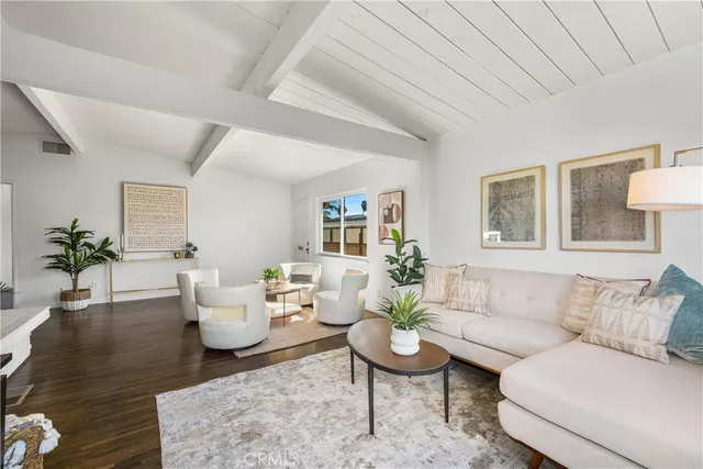 a living room with furniture and a potted plant