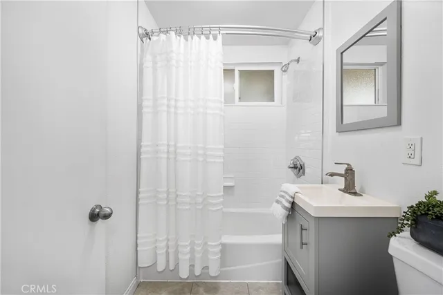 a bathroom with a shower curtain and a sink