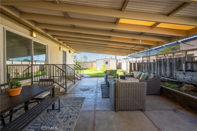 a view of a patio with a table and chairs